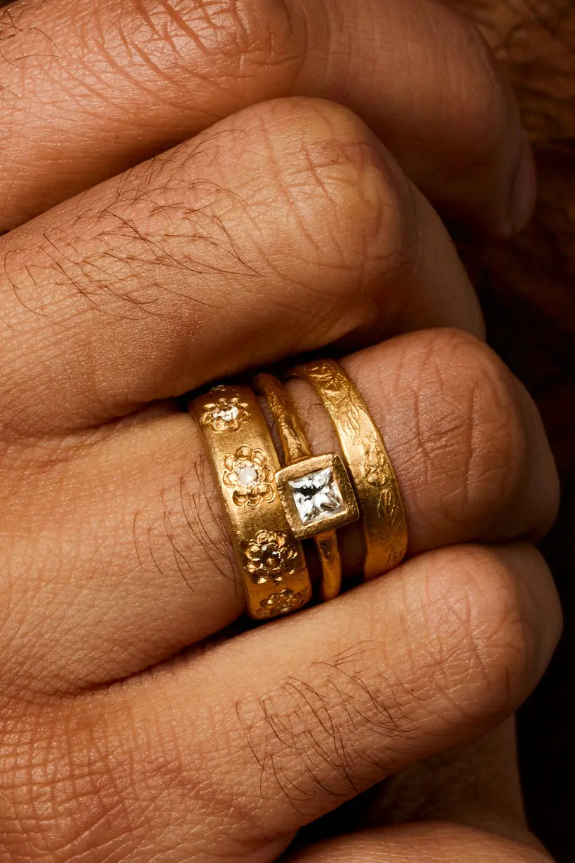 Clover Ring worn with other perfect imperfect gold rings form the Radiance collection