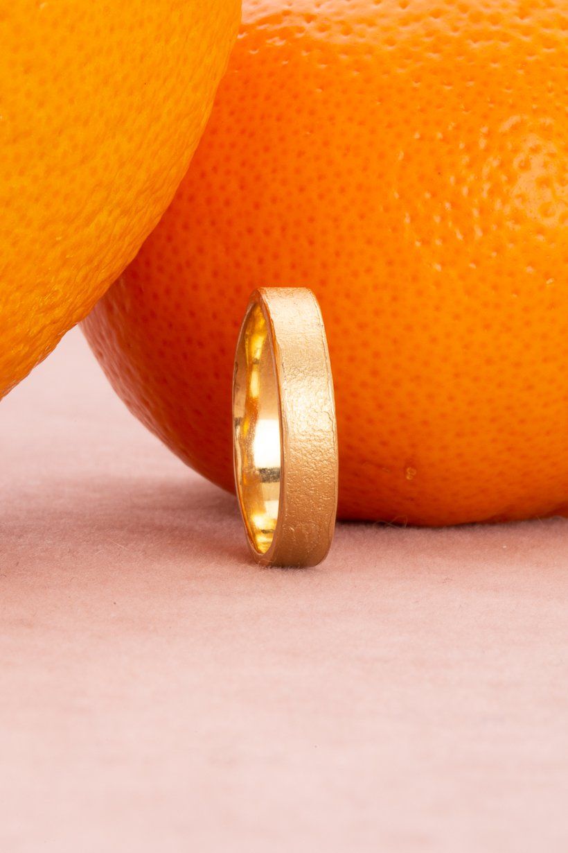 Side view of Citrus Ring – clean silhouette with hand-textured citrus pattern. Golden, unique mens wedding ring