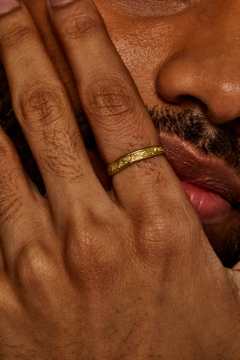 Grapevine Ring worn on hand – softly detailed gold wedding band with natural leaf and grape pattern