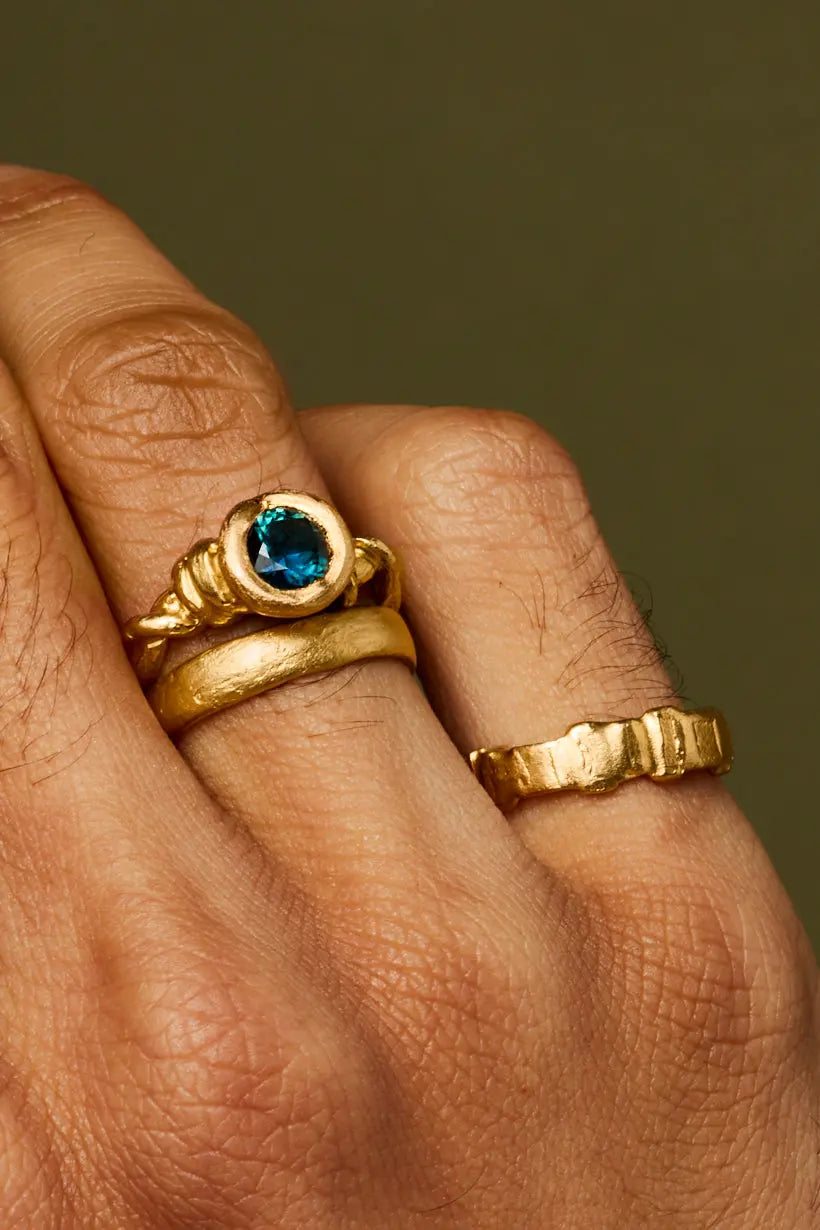 Model wearing the Liana Ring stacked with gold bands