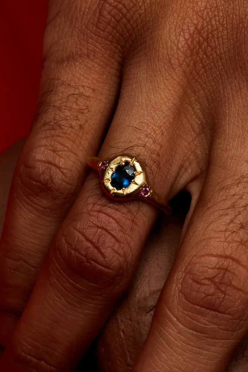 Monet’s Garden Ring worn on hand, showcasing the trio of sapphires in yellow gold