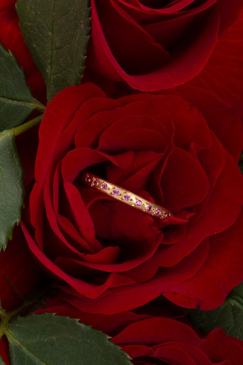 Detailed photo of Rosette ring in 18ct yellow gold with hot pink sapphires sitting in a rose.