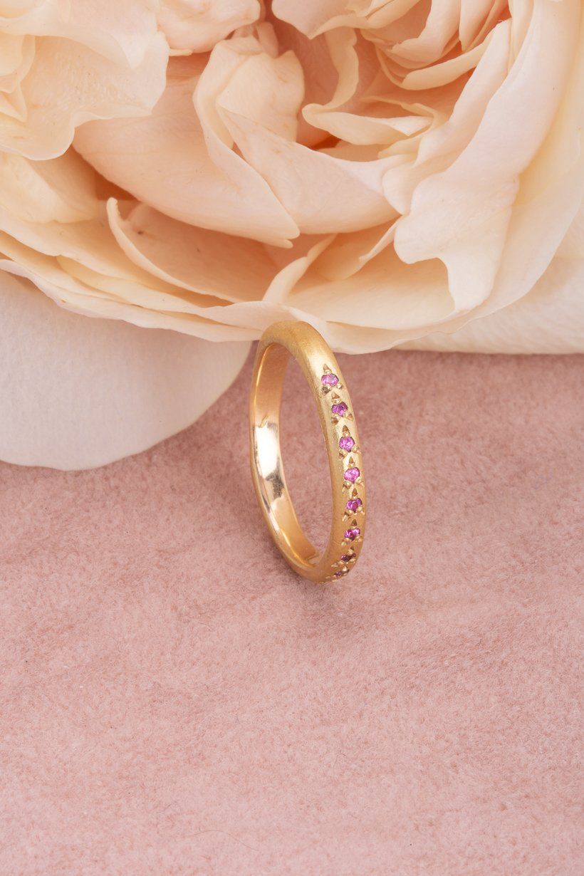 Side angle of the Rosette Ring showing the rosette settings holding each pink sapphire.