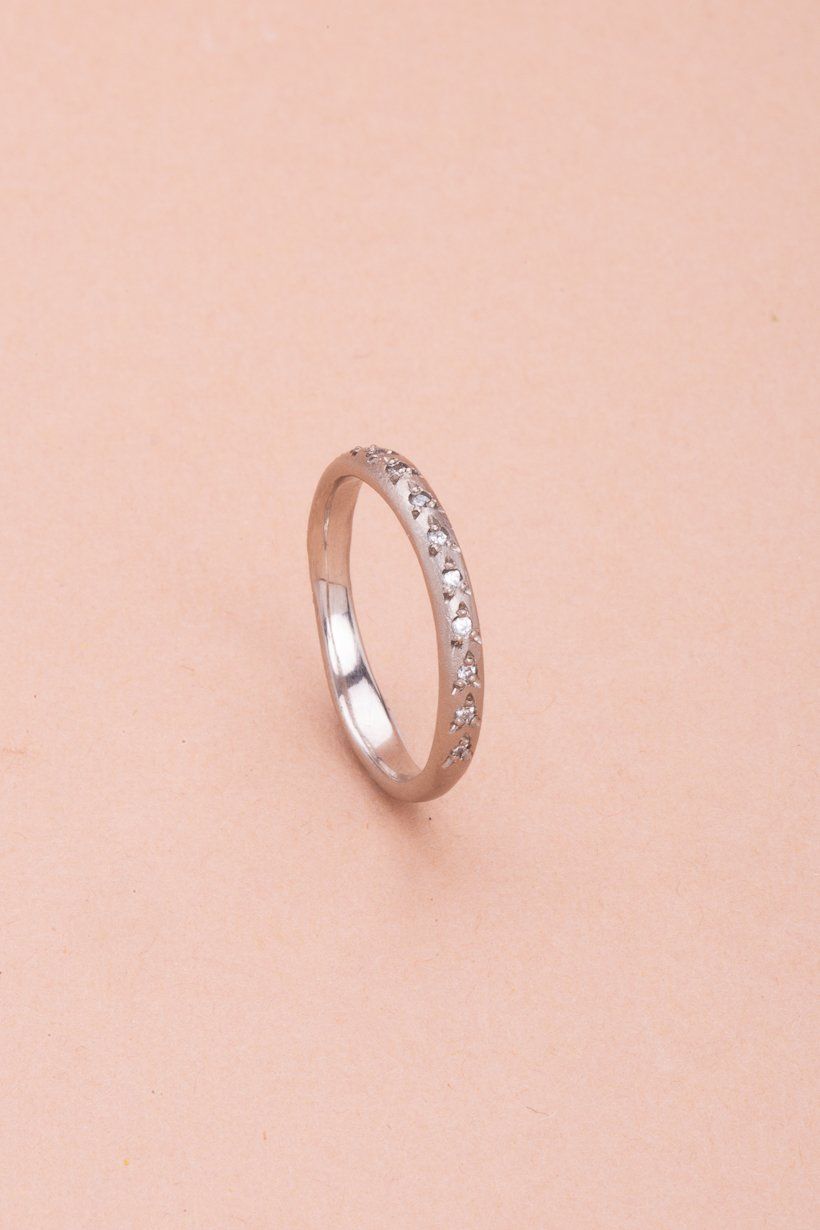 Detail shot highlighting the subtle texture of the white gold and shimmer of diamonds
