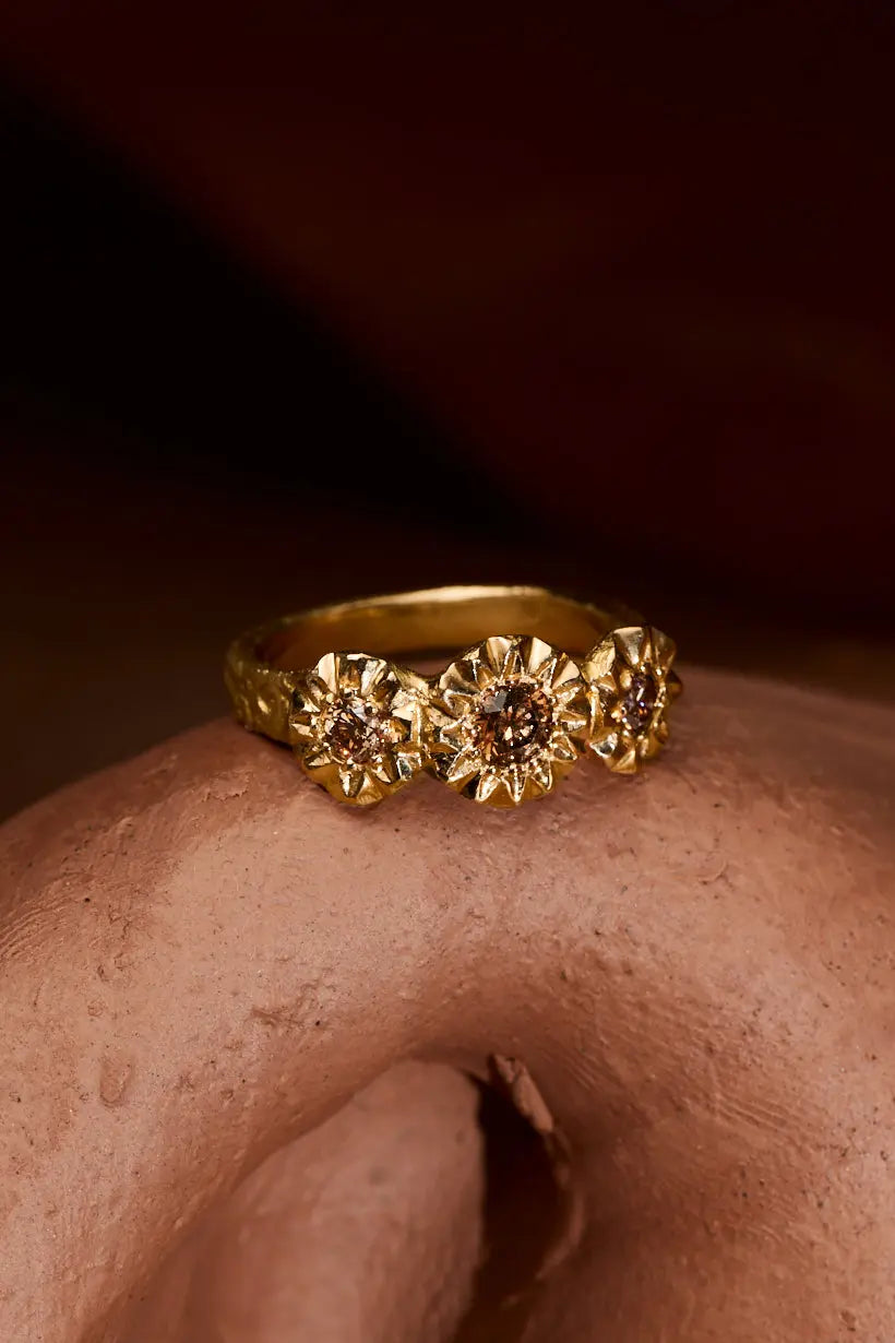 Detailed sunflower settings and engraving on Ada Hodgson’s Sunflower Ring in 18ct recycled gold