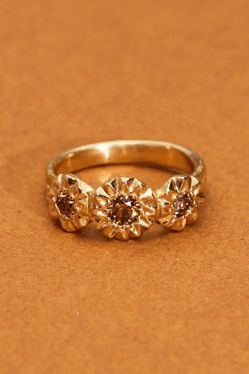 Sunflower Ring by Ada Hodgson – three champagne diamonds set in 18ct yellow gold with sunflower-style settings