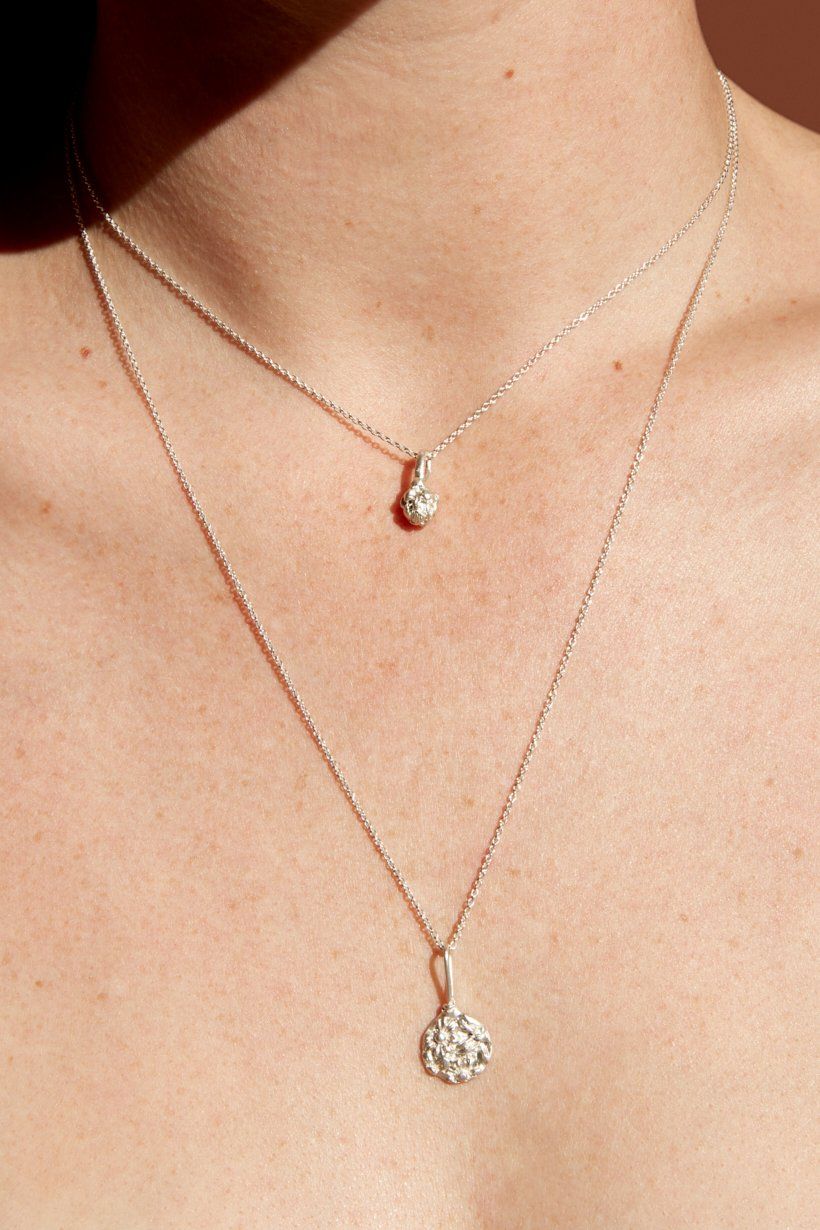 Floral Relic necklace in sterling silver hanging with the Artichoke pendant on a model, showing the length of the 50cm chain