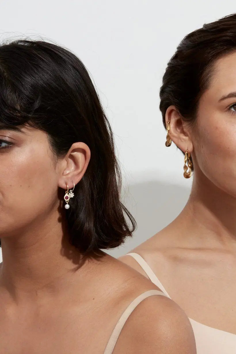 Daisy Sleepers worn in second piercings on model – styled with Royal earrings in first piercing