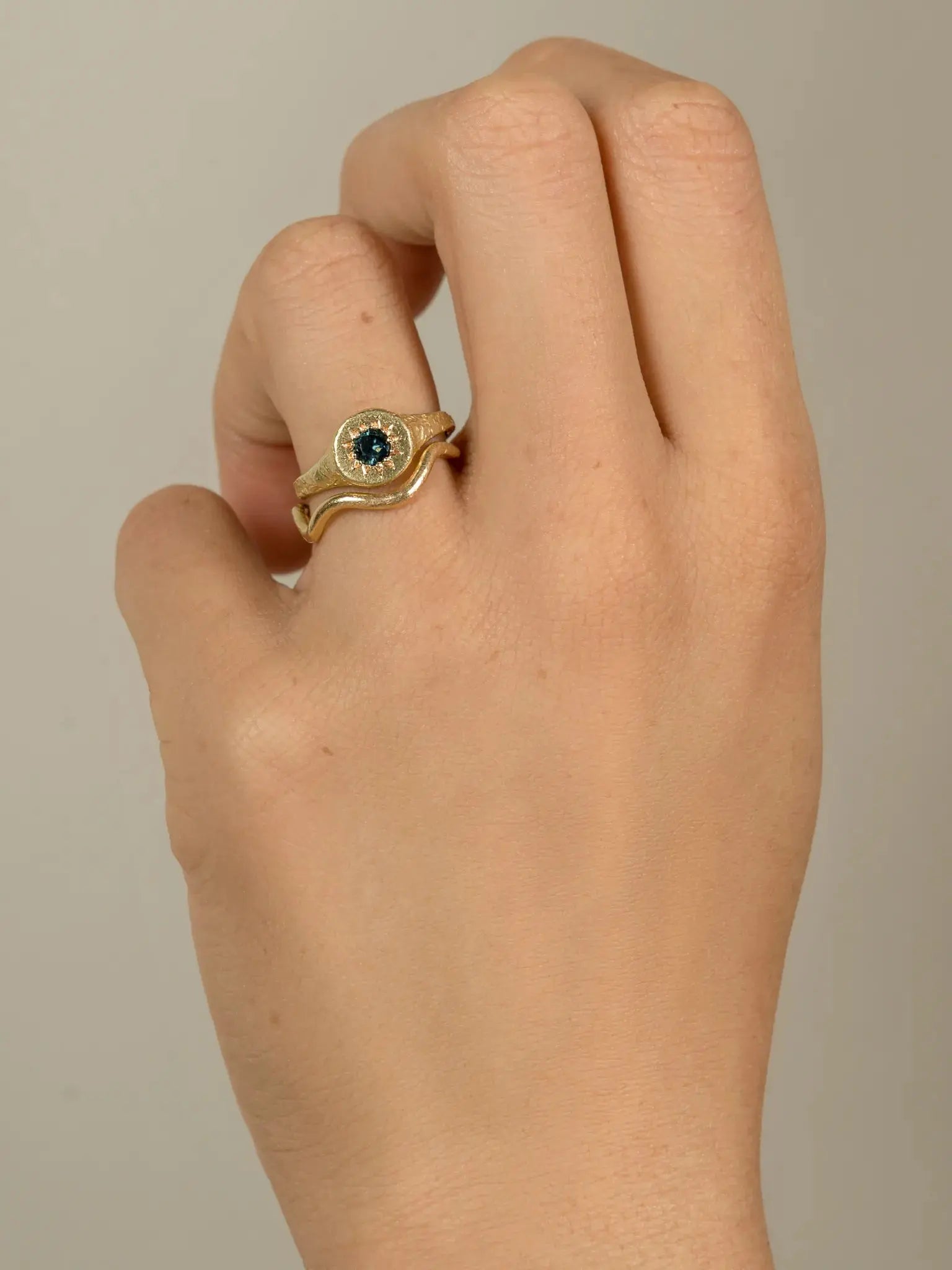 Floral Relic Signet Ring worn on hand in soft natural light