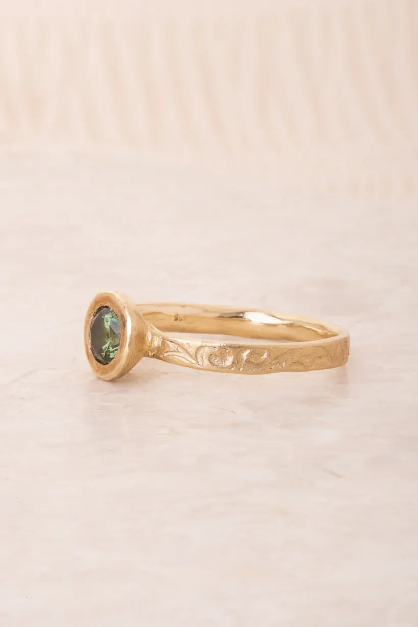 green Australian sapphire set in textured and organic 9ct yellow gold. 