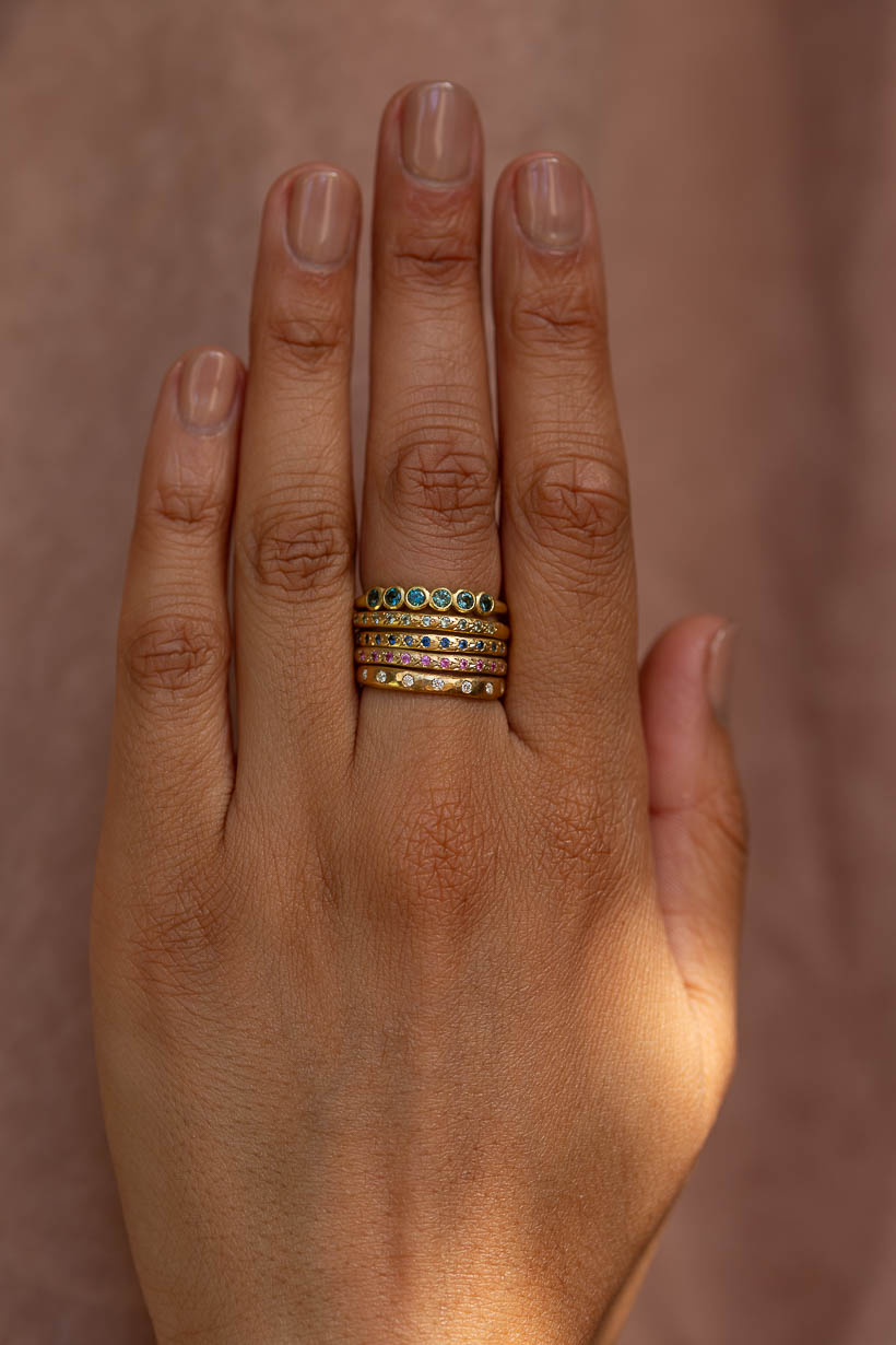 Gumnut sapphire wedding band, Dewfall diamond band and Rosette ring stacked on the hand, handmade in Melbourne by Ada Hodgson