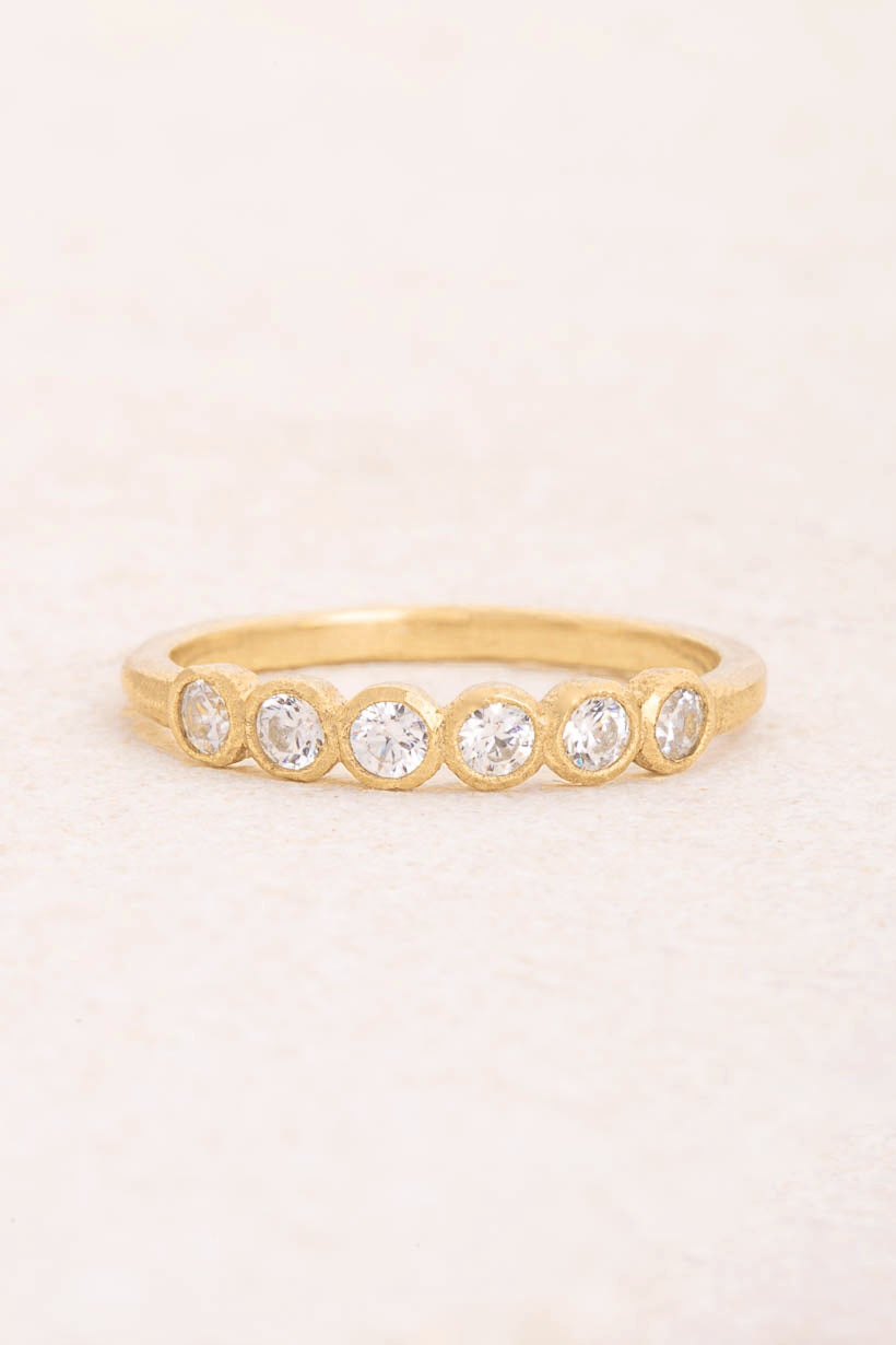 Gumnut wedding band with six white diamonds in textured bezel settings on a 1.9mm recycled gold band, Ada Hodgson