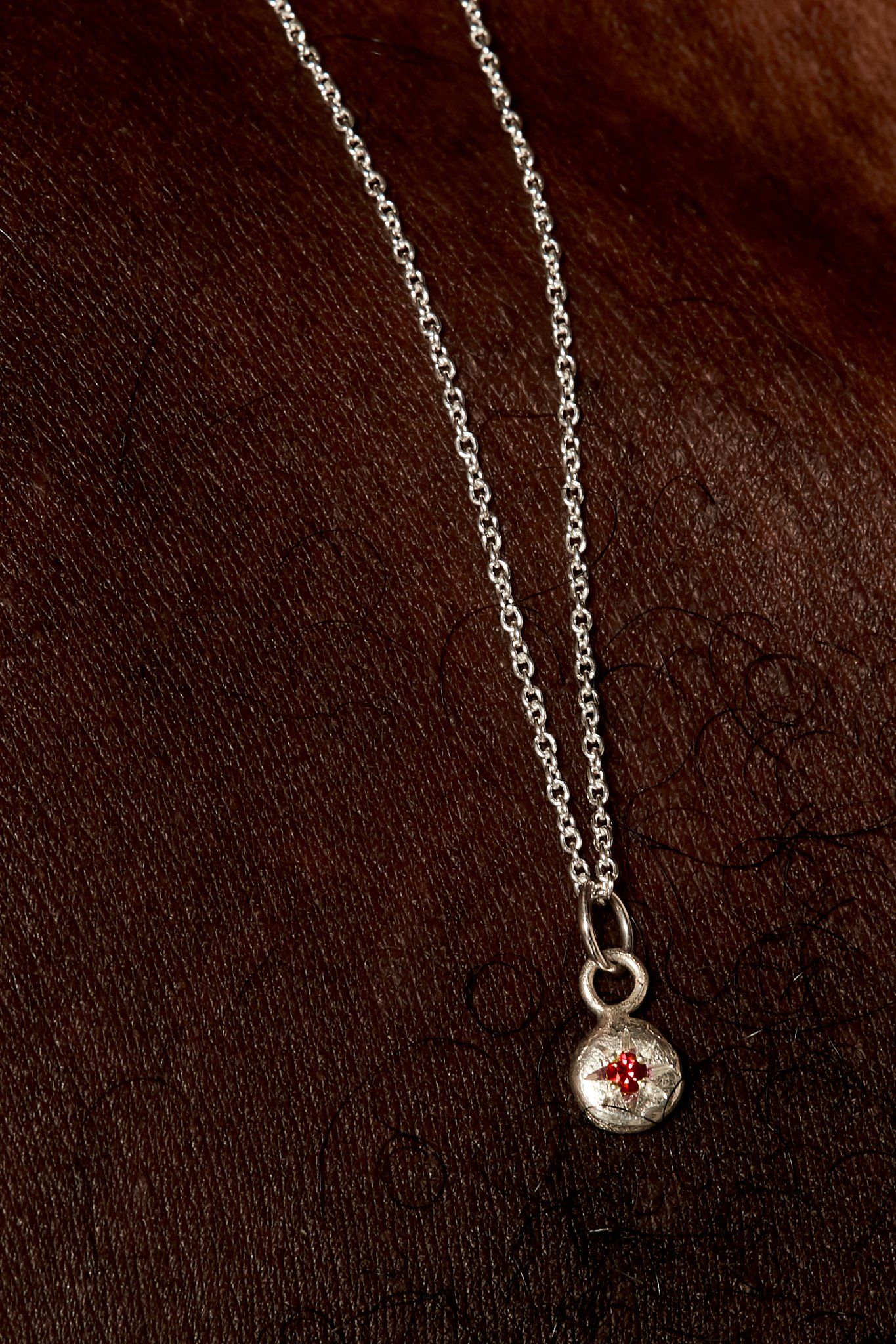 Sterling silver January birthstone necklace with star-set garnet