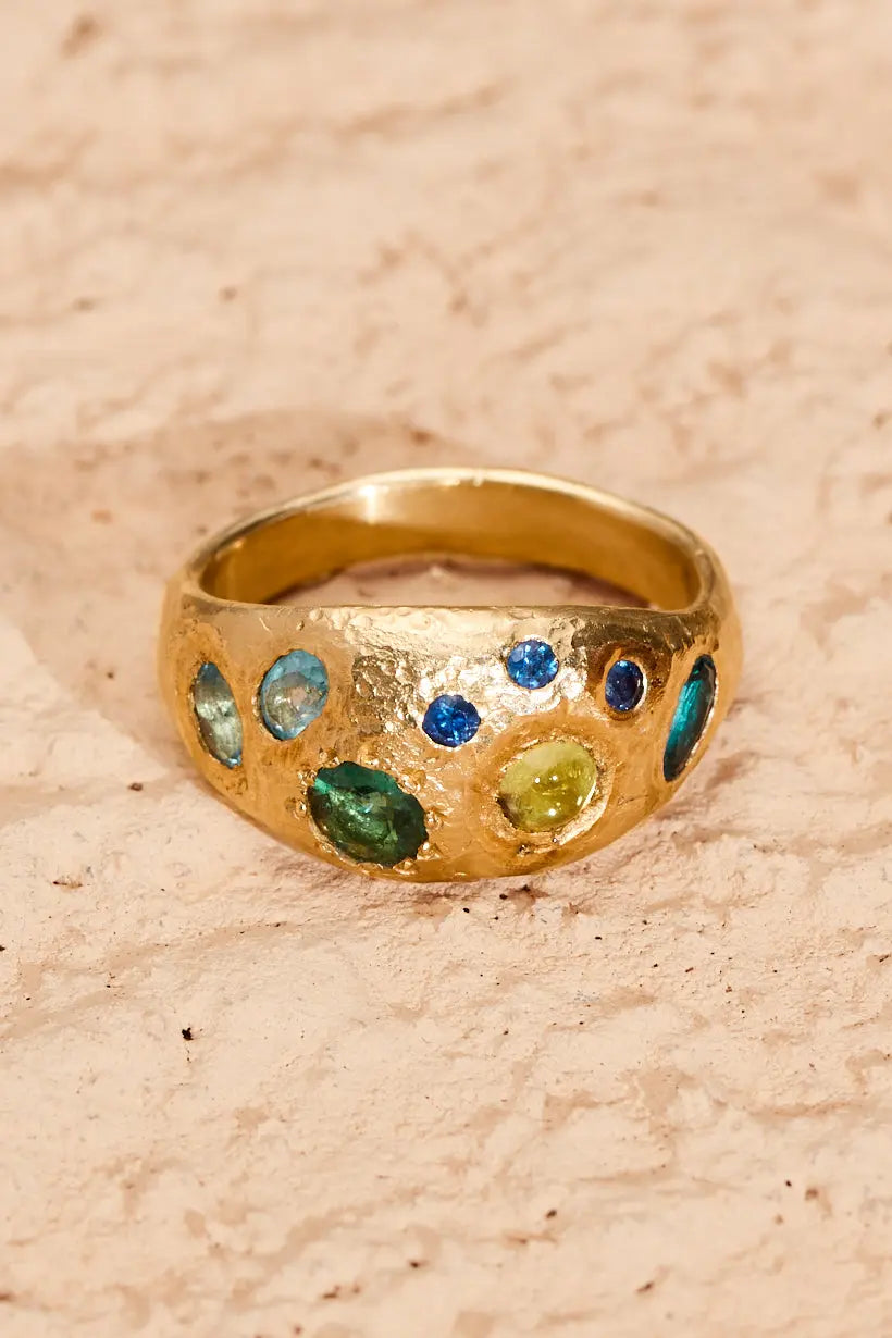 Detailed close up of the Rockpool Ring. Sapphires, tourmaline, peridot, topaz set in textured gold. A thick statement ring. Handmade in Melbourne