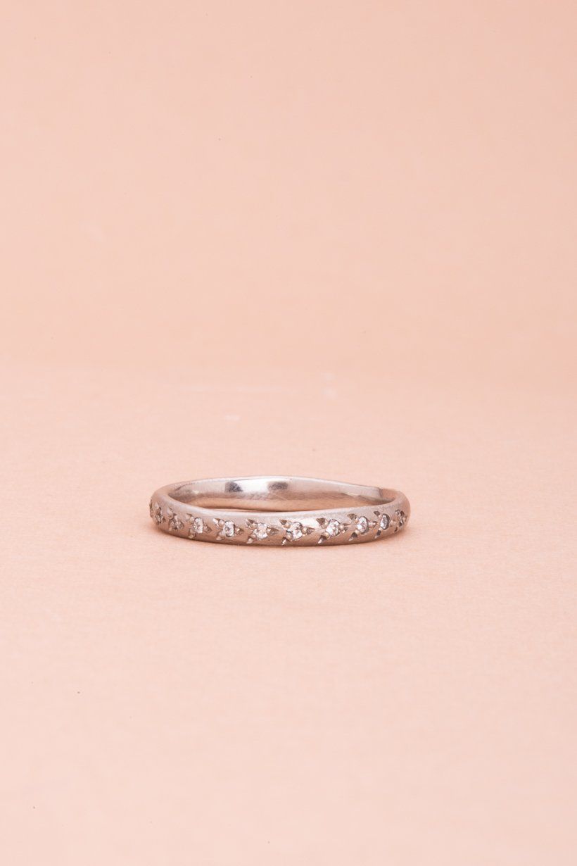 Detail shot highlighting the subtle texture of the white gold and shimmer of diamonds