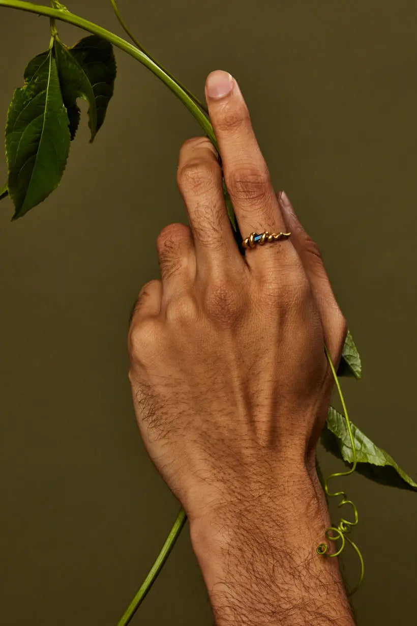 Vine Ring styled on model hand, slender band with sapphire centerpiece